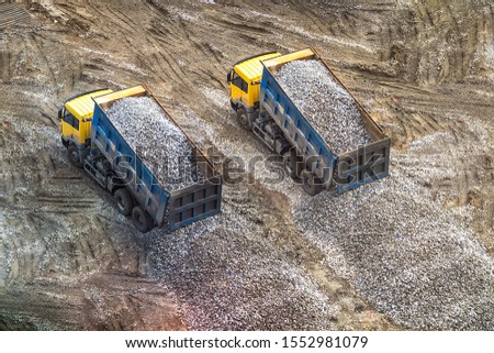 truck unloads rubble to the ground, rock, gravel 