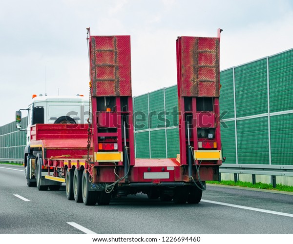 Truck wihout trailer box at the highway\
asphalt road, Poland. Truck\
transporter