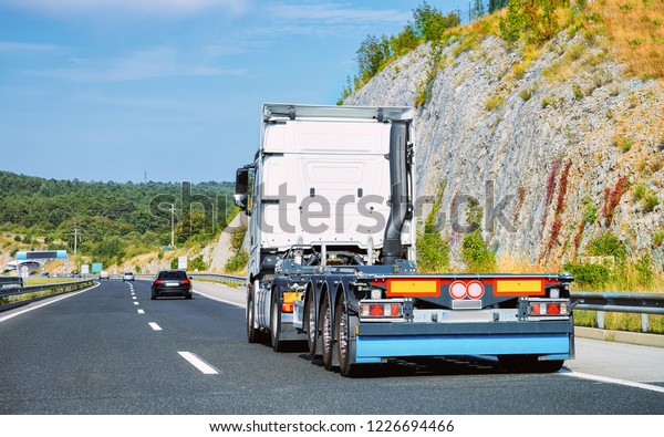 Truck wihout trailer box on the highway\
asphalt road of Poland. Truck\
transporter