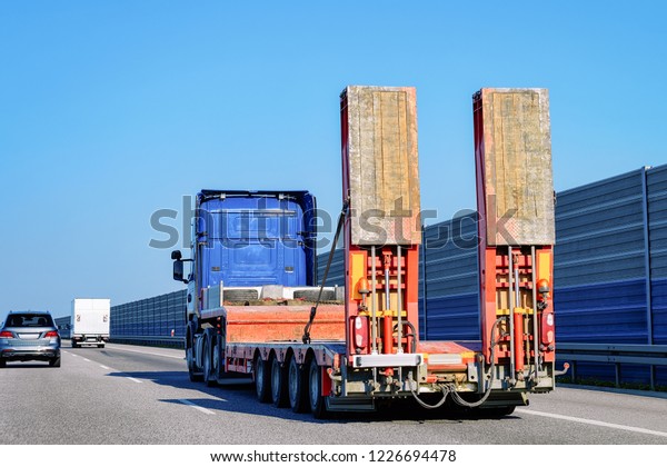 Truck wihout trailer box on the highway
asphalt road of Poland. Truck
transporter