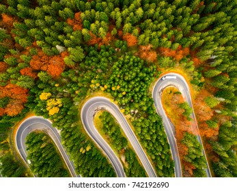 Truck Winding Up Its Way On A Curvy Road Through Autumn Colored 