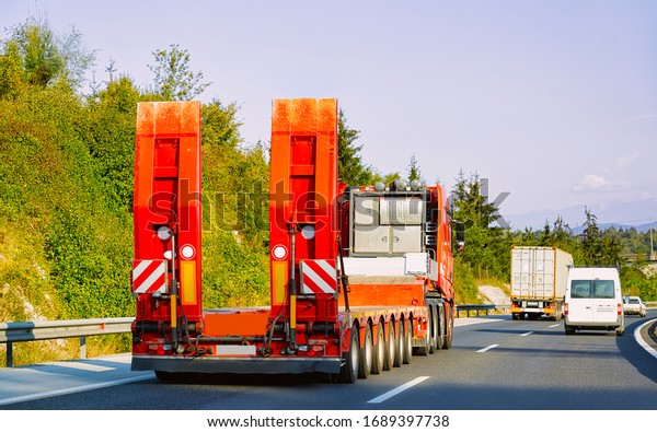 Truck without trailer box at the highway\
asphalt road of Poland. Truck\
transporter