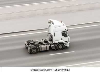 A truck without a trailer rushes along the road