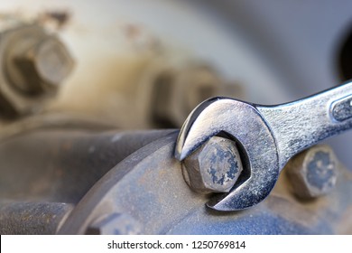 Truck wrench maintenance,The mechanic using a torque wrench truck nut wheel in service center,spot focus. - Powered by Shutterstock