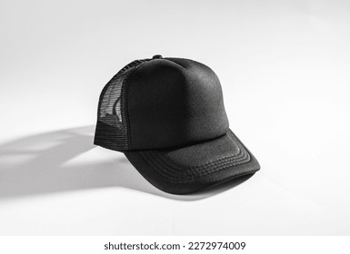 Trucker cap, snapback, all black, black mesh. Isolated on white. Mock-up for branding