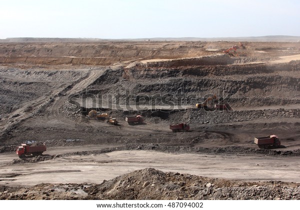 trucks carry ore open\
pit