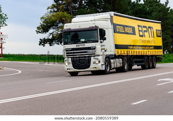 Trucks are carrying cargo. Background with copy\
space for text or inscriptions. Illustrative editorial. May 25,\
2021 Balti Moldova.