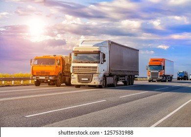 trucks goes on highway in evening on sunset - Shutterstock ID 1257531988