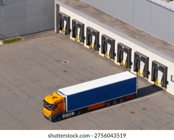 Trucks handle cargo at loading docks of a logistics center during daylight. Warehouse operations manage supply chain activities. - Powered by Shutterstock - Get 15% off with code: PIKWIZARD15
