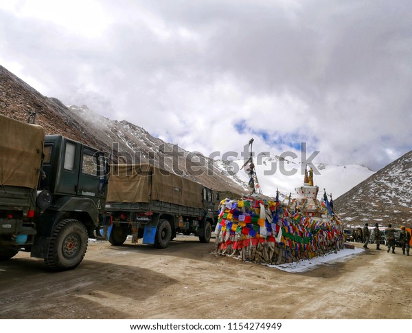 The trucks of Indian military convoy park on the\
Changla Pass, the world\'s second highest road. Leh, Ladakh, India.\
June 2018.