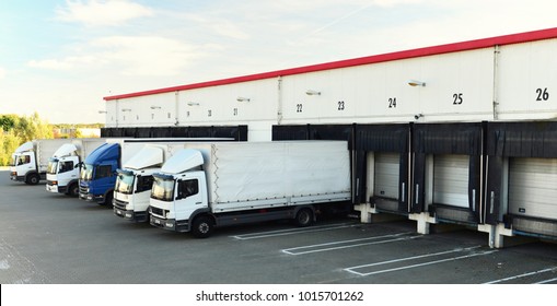 Trucks Are Loaded With Goods At The Depot In A Shipping Company