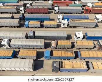 Trucks loaded with grain are waiting, top view. Trucks in the port terminal are waiting to be unloaded