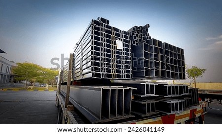 Trucks with long trailers carrying steel bars for building construction. Construction steel is ready to be delivered to the customer.Steel in thailand