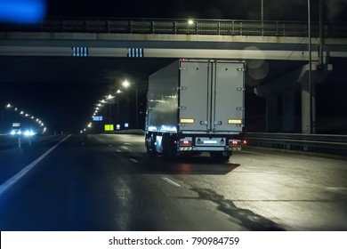 Trucks move on a night freeway