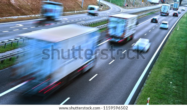 Trucks on four lane controlled-access highway\
in Poland.\
