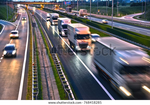 Trucks on four lane controlled-access highway\
in Poland.\
\
