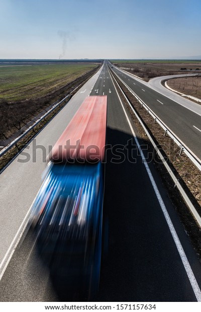 Trucks
on a highway in autumn landscape. View from
above.