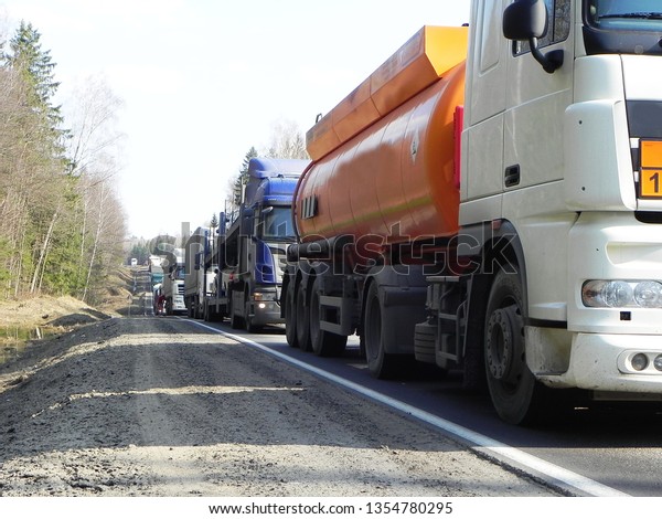 Trucks are on the road.\
Because of the road works, a traffic jam has accumulated on the\
highway.