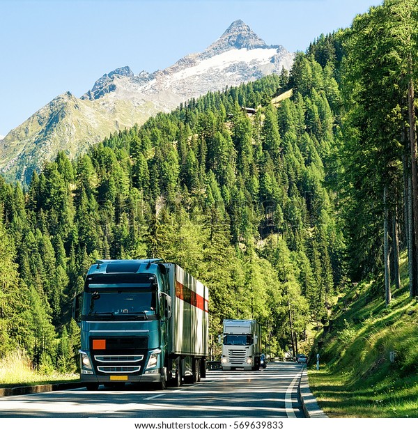 Trucks on\
the road in Visp, Valais canton in\
Swiss.