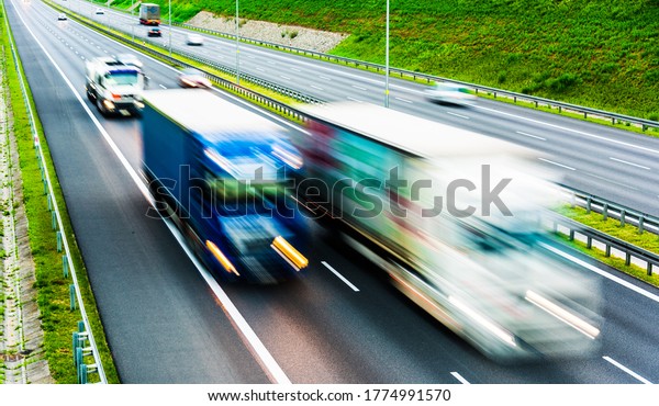 Trucks on six lane controlled-access highway\
in Poland.\
\
