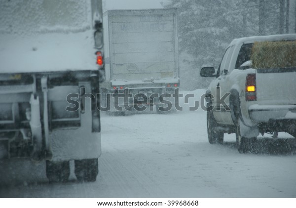 Trucks on winter highway during snowstorm,  
Oregon, Pacific
Northwest