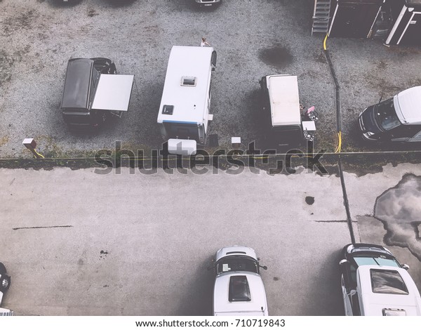 Trucks settlement. Aerial view of camping in\
Stockholm, Sweden. Summer seascape with trucks, sunny day. Top view\
from flying drone