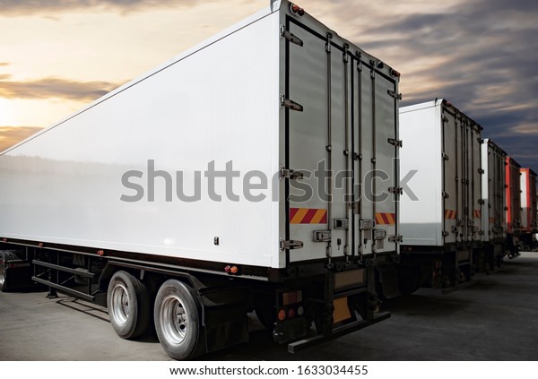 Trucks shipping\
container parking at sunset sky, Road freight industry cargo\
service, Logistics and transport\
