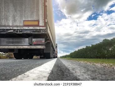 Trucks Are Stuck In Traffic. A Column Of Semi-trailers On The Freeway. Concept Of Disruption In Transportation Logistics And Supply Chains