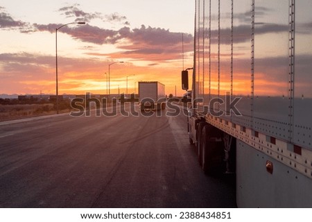 trucks and traffic at sunset. highway road 