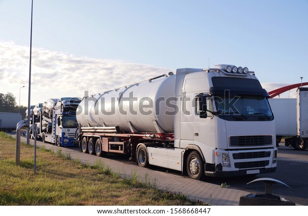 Trucks\
transporting various goods. Photo shows a tanker and a truck for\
transporting passenger cars. Road transport.\
