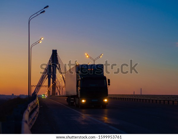 Trucks vehicle on highway in beauty morning\
light. Cargo transportation and\
supply