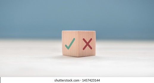 True and false symbols accept rejected for evaluation, Yes or No on wood blogs on blue background.