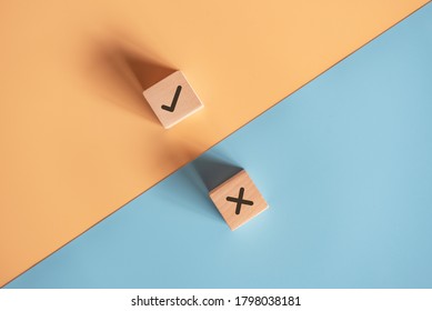 True and false symbols accept rejected for evaluation, Yes or No on wood blogs on blue and yellow background. - Shutterstock ID 1798038181
