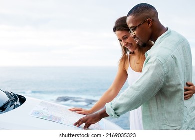 True love never leads you astray. Shot of a happy young couple reading a map on a road trip along the coast. - Powered by Shutterstock