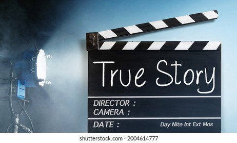 True story.Text tile on film slate. and Movie industry in backgrounds - Shutterstock ID 2004614777
