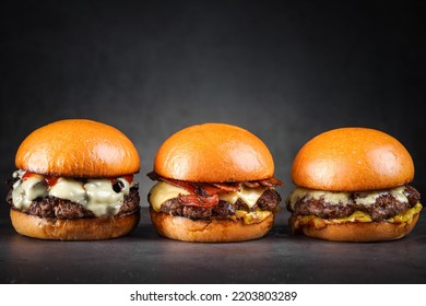 Truffle cheese burger, Bacon cheese burger, Wagyu cheese burger on dark grey background. - Powered by Shutterstock