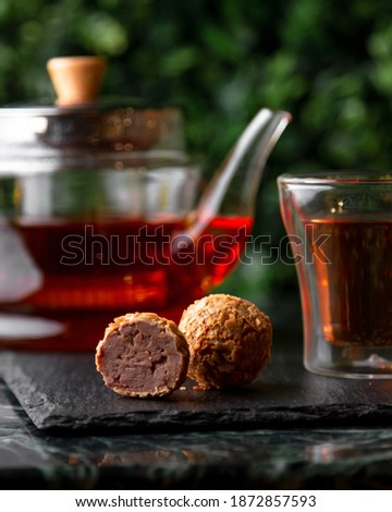 Truffle on the table with a cup of tea