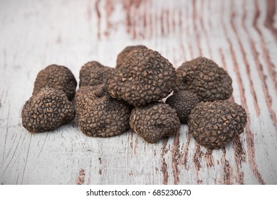 Truffles On The White Table. Black Truffle, Tuber Melanosporum, Périgord Truffle Or French Black Truffle