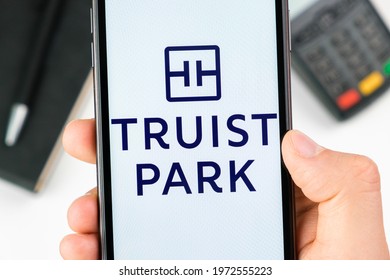 Truist Park Bank Logo On The Smartphone Screen In Mans Hand On The Background Of Payment Terminal, May 2021, San Francisco, USA