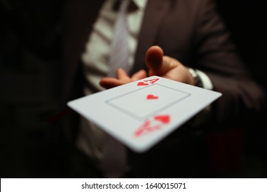 Trump in the sleeve, strategy business card game. Gambling cards, man suit throws card to floor. Man in suit throws card. Gambling creates annoyance and frustration. Player throws game. - Powered by Shutterstock