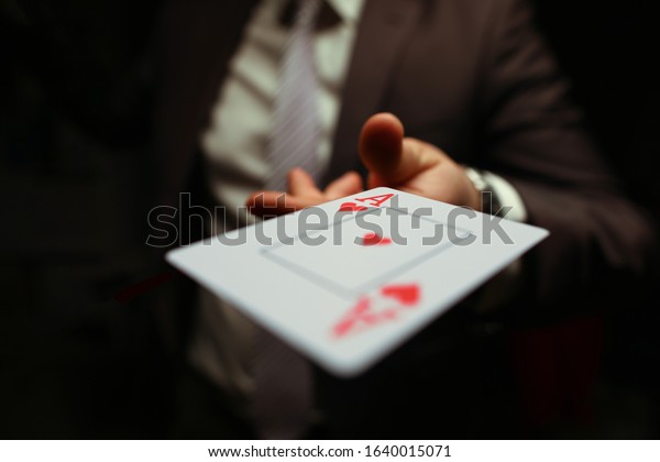 Trump in the sleeve, strategy business card game.\
Gambling cards, man suit throws card to floor. Man in suit throws\
card. Gambling creates annoyance and frustration. Player throws\
game.