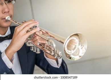 Trumpet instrument and Musician playing a trumpet in studio