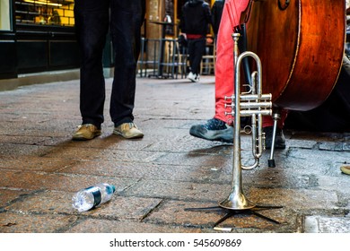 Trumpet On A Ground .artists Street Busker Performing Jazz Songs Outdoors. Close Up Of Big Tube