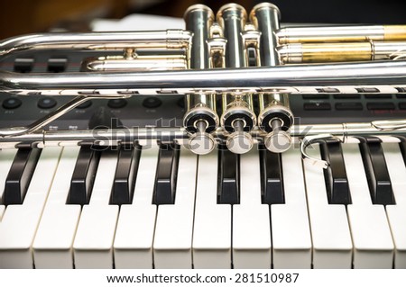 Trumpet on keyboard background