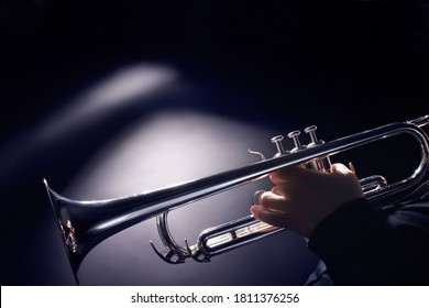 Trumpet player playing jazz music instrument. Brass jazz player trumpeter hands closeup