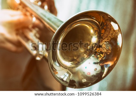 The trumpeter is playing on a silver trumpet. Trumpet player Сток-фото © 