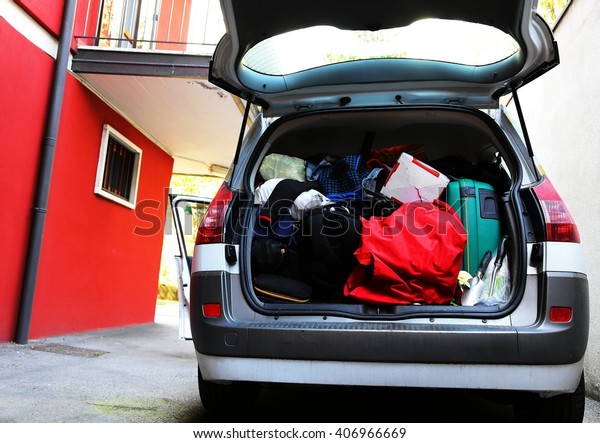 trunk of the car overloaded with bags\
and luggage before the summer holiday\
departures