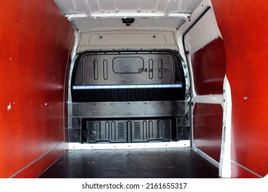 Trunk Of A Modern Cargo Van. Rear View Of A Modern Cargo Van Vehicle With Open Trunk And Loading Compartment.