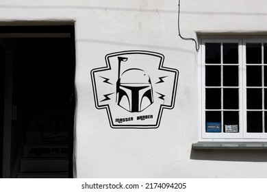 Truro, UK  June 30th 2022  A Barbers Shop Exterior With Star Wars Mandalorian Inspired Logo And Master Barber Written On The White Exterior Stucco Wall Of An Old English Building