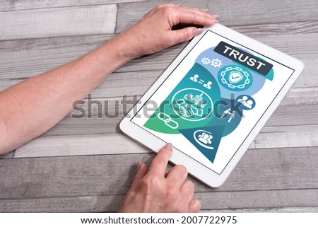 Trust concept shown on a tablet used by a woman